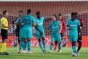 Barcelona's Argentinian forward Lionel Messi (C) celebrates after scoreing a goal during the Spanish League football match between RCD Mallorca and FC Barcelona at the Visit Mallorca stadium (Son Moix stadium) in Palma de Mallorca on June 13, 2020. / AFP / JAIME REINA