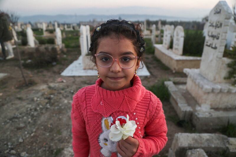 Syrian earthquake survivor Yasmine Al Sham in the cemetery of Jindayris, in Aleppo province. Save the Children says many young survivors are 'struggling to process everything they have endured'. AFP
