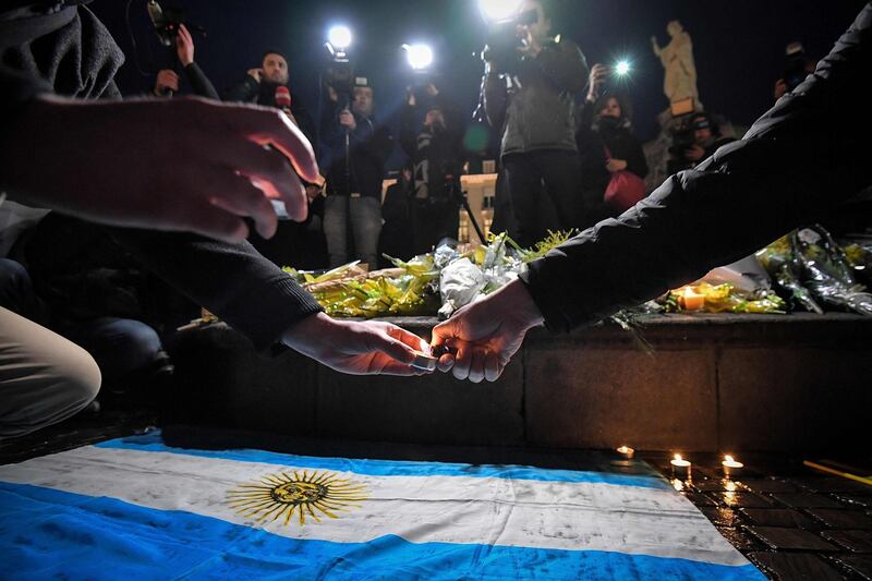 Nantes supporters gather and light candles over an Argentinian flag. AFP