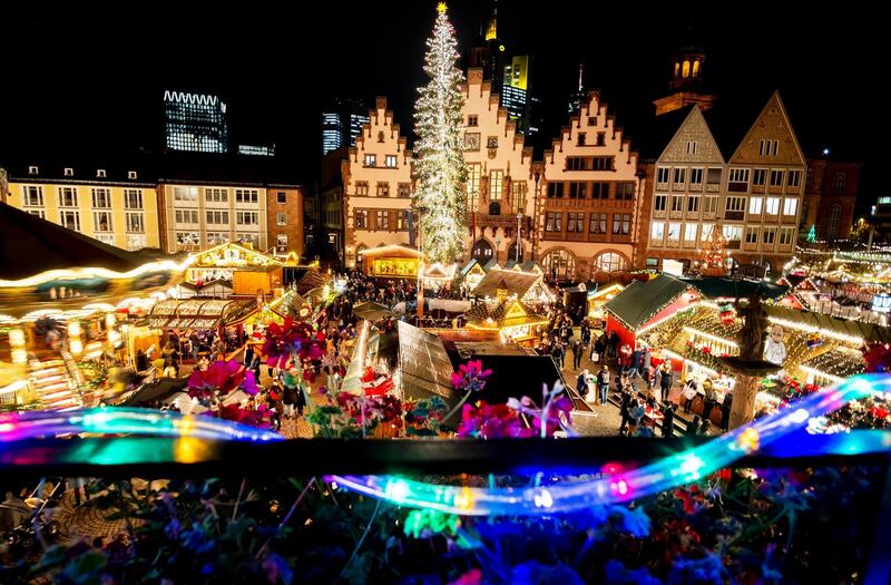 People gather on the Roemerberg Square to visit the traditional Christmas market in Frankfurt, Germany.  AP