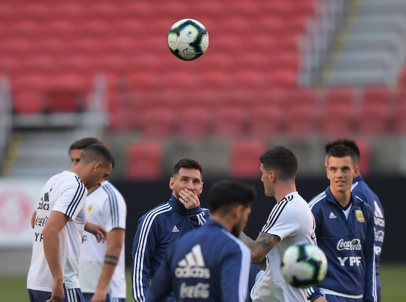 Argentina's Lionel Messi speaks to a teammate during a training session. AFP