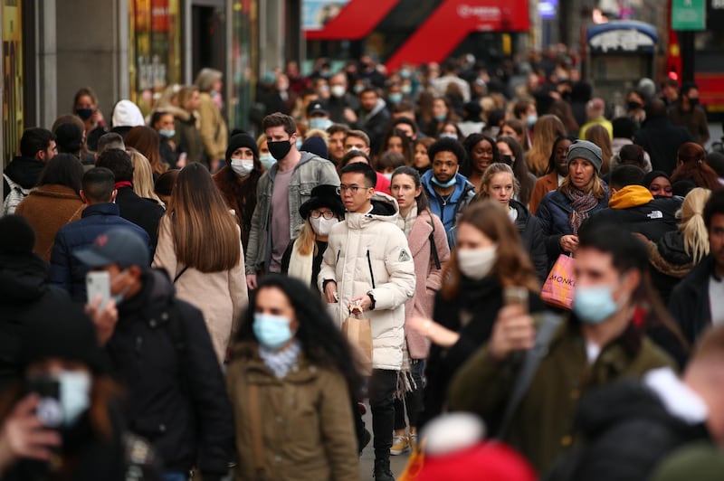 Shoppers, some wearing face masks, walk along a busy Oxford Street in London, England, on December 5, 2020. London has returned to so-called Tier 2 or 'high alert' coronavirus restrictions since the end of the four-week, England-wide lockdown last Wednesday, meaning a reopening of non-essential shops and hospitality businesses as the festive season gets underway. Rules under all three of England's tiers have been strengthened from before the November lockdown, however, with pubs and restaurants most severely impacted. In London's West End, meanwhile, Oxford Street and Regent Street were both packed with Christmas shoppers this afternoon, with the retail sector hoping for a strong end to one of its most difficult years. (Photo by David Cliff/NurPhoto via Getty Images)