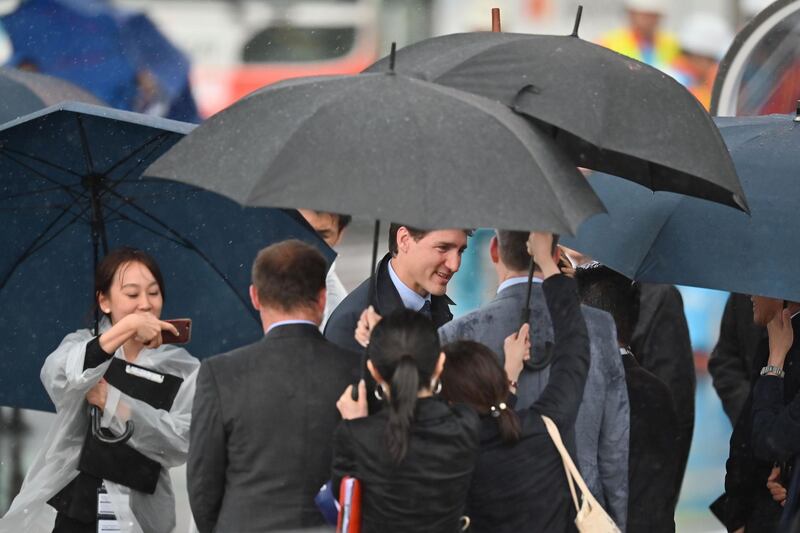 Canadian Prime Minister Justin Trudeau (C) arrives at Kansai airport in Izumisano city, Osaka prefecture,  ahead of the G20 Osaka Summit. AFP