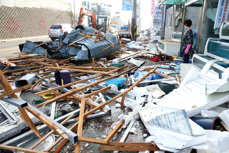 A woman looks at debris caused by Typhoon Maysak in Pohang, South Korea. Reuters