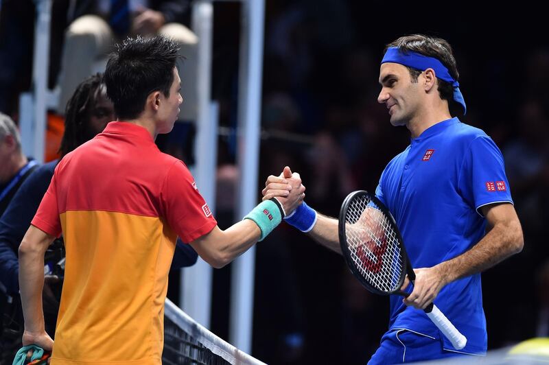 Japan's Kei Nishikori (L) greets Switzerland's Roger Federer after winning their singles round robin match 7-6, 6-3 on day one of the ATP World Tour Finals tennis tournament at the O2 Arena in London on November 11, 2018.  / AFP / Glyn KIRK                  
