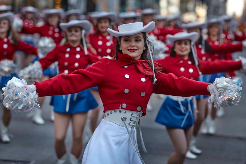 Performers move through Sixth Avenue. AP Photo