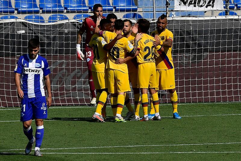 Barcelona players celebrate a goal from Luis Suarez against Alaves. AP Photo