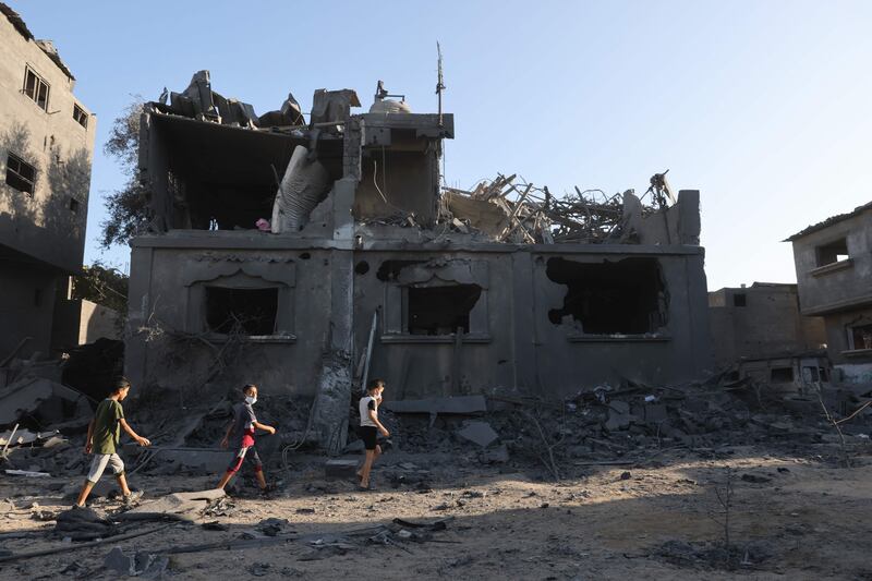 Palestinian children walk amid the rubble the day after an Israeli air strike in Gaza. AFP