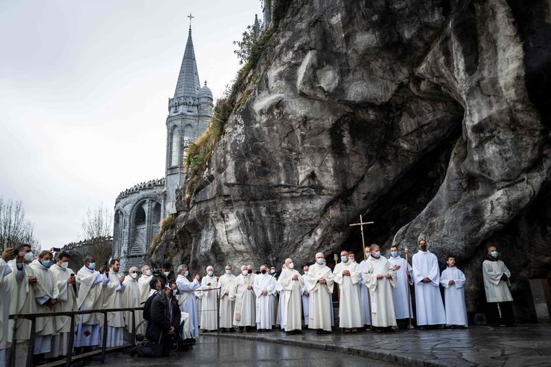Priests attend the reopening of the cave at Massabielle in the Sanctuary of Our Lady of Lourdes in Lourdes, south-west France after almost two years, as Covid-19 restrictions are eased. AFP
