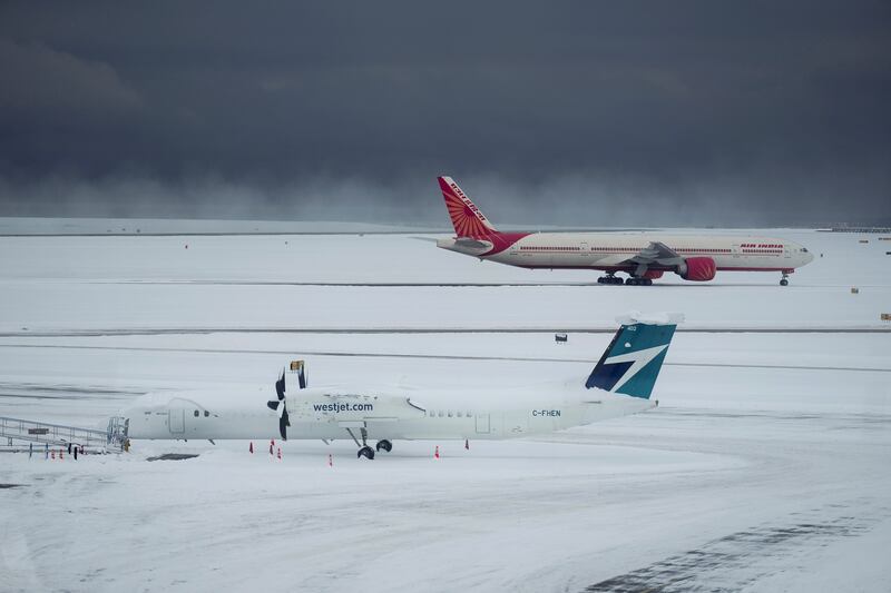 Westjet and Air India aircraft at Vancouver Airport after a snowstorm led to cancellations and major delays. AP