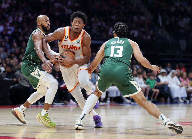 De'Andre Hunter of Atlanta takes on Jevon Carter of Milwaukee.