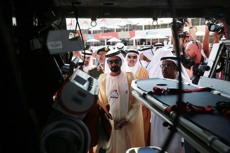 Sheikh Mohammed bin Rashid takes a look at one of the aircraft on static display at the Dubai Airshow. Christopher Pike / The National