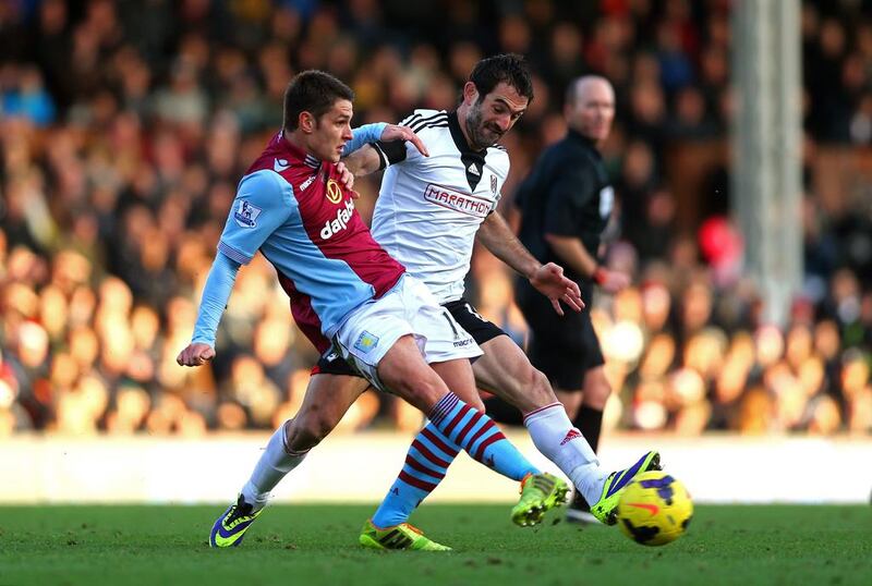 Ashley Westwood, left, of Aston Villa passes the ball under pressure from Giorgos Karagounis of Fulham during their match on Sunday afternoon. Paul Gilham / Getty Images