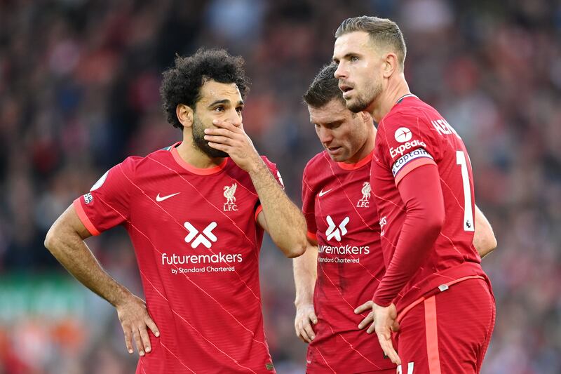 Mohamed Salah of Liverpool speaks with teammates James Milner and Jordan Henderson. Getty Images