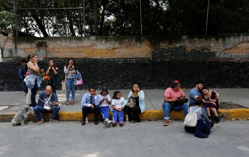 People and children are seen on a street after an earthquake in Mexico City. Claudia Daut / Reuters