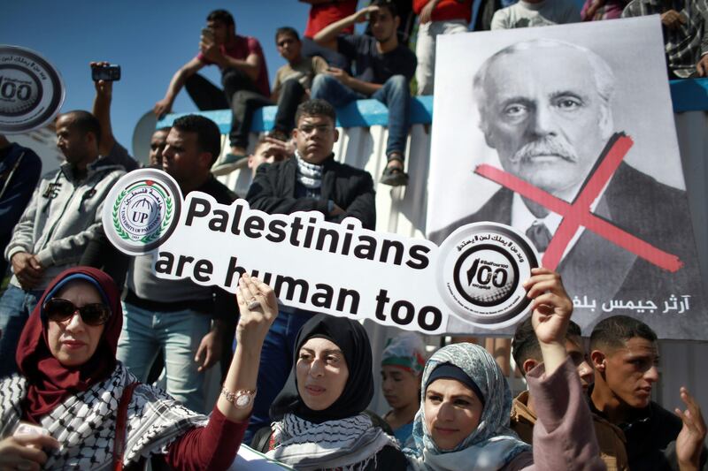 Palestinians protest in front of the Office of the United Nations Special Coordinator for the Middle East Peace Process headquarters, marking the 100th anniversary of the Balfour Declaration, in Gaza City, Thursday, Nov. 2, 2017. The Balfour Declaration, Britain's promise in 1917 to Zionists to create a Jewish home in what is now Israel, turns 100 this week. (AP Photo/ Khalil Hamra)