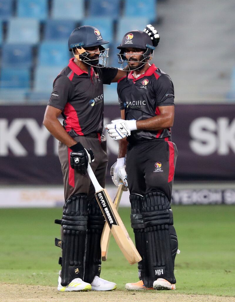 UAE's CP Rizwan, right, after reaching 50.