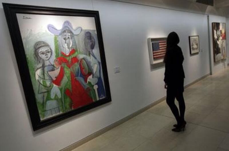 A 1961 Pablo Picasso painting titled Femme et Fillettes and Jasper Johns's Stars and Stripes painting, Flag, are among the works collected by the late author Michael Crichton that are going up for auction.