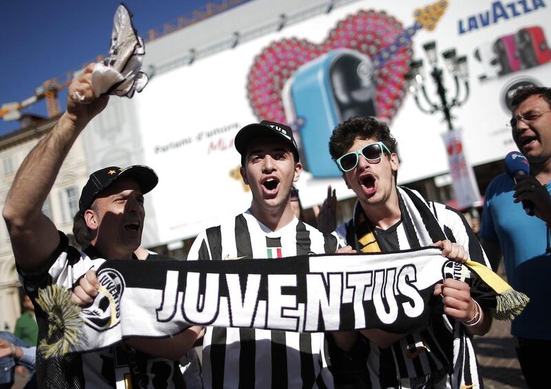 Juventus supporters celebrate after their club sealed up the Serie A title on Sunday. Marco Bertorello / AFP / May 4, 2014