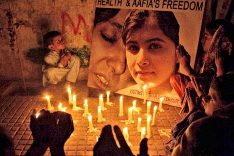 Pakistani children in Hyderabad hold a vigil on Saturday for shot child activist Malala Yousufzai.