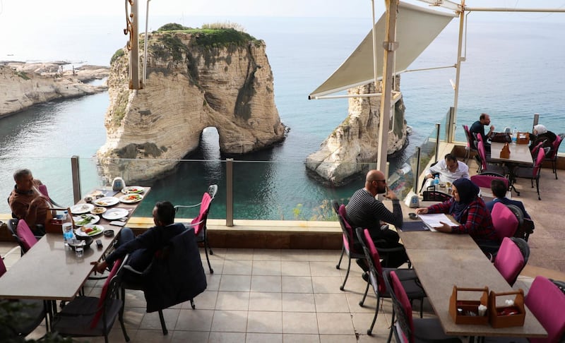 People sit at a restaurant that has reopened, as the coronavirus disease restrictions are eased, in Beirut, Lebanon. Reuters