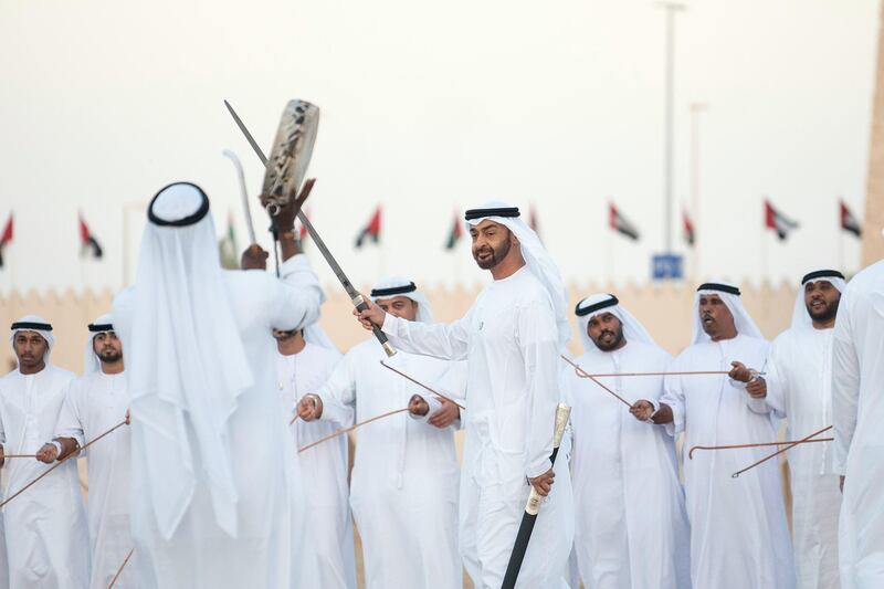 AL WATHBA, ABU DHABI, UNITED ARAB EMIRATES - December 3, 2018: HH Sheikh Mohamed bin Zayed Al Nahyan, Crown Prince of Abu Dhabi and Deputy Supreme Commander of the UAE Armed Forces (C), dances during the Sheikh Zayed Heritage Festival.
( Ryan Carter / Ministry of Presidential Affairs )
---