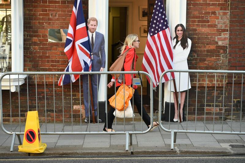 A pedestrian walks past cut-out figures. Oli Scarff / AFP Photo