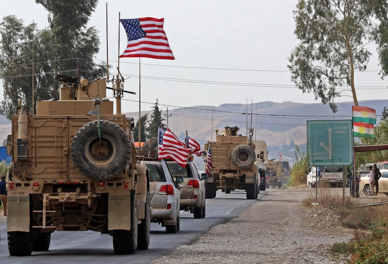A convoy of US military vehicles arrives near the Iraqi Kurdish town of Bardarash in the  Dohuk governorate after withdrawing from northern Syria. AFP