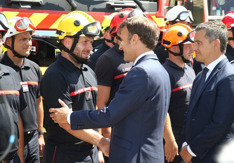 France's Prime Minister Emmanuel Macron meets firefighters in La Test-de-Buch, near Arcachon, south-western France, where two massive fires feeding on tinder-dry pine forests have forced tens of thousands of people to flee. AP