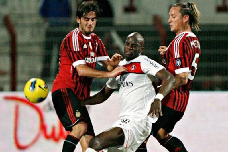 Paris Saint-Germain's Clement Chantome, centre, cannot escape the attention of AC Milan's Alberto Aquilani, left, and Philippe Mexes.