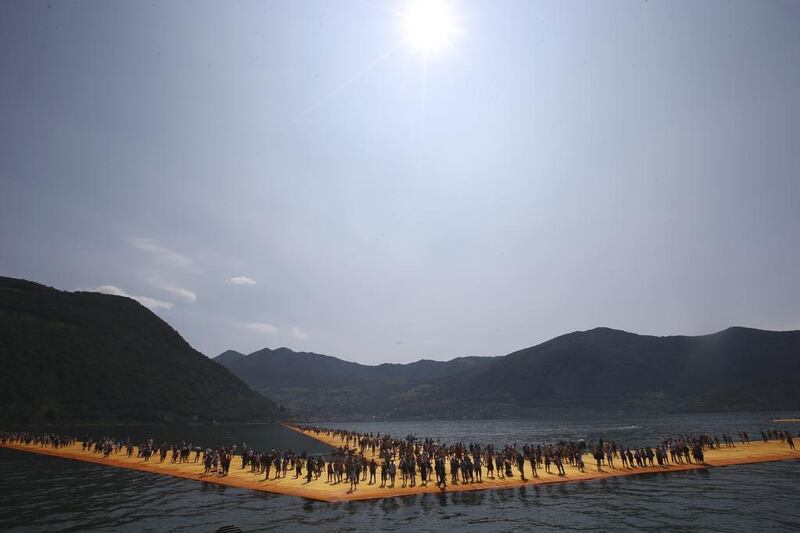 People walk on the installation The Floating Piers at the Iseo Lake. Luca Bruno / AP photo