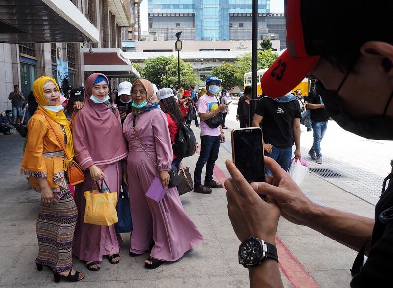 Three Indonesian women pose for photographs while celebrating Eid Al Fitr, which marks the end of Ramadan, at the Taipei Railway Station in Taipei, Taiwan. EPA