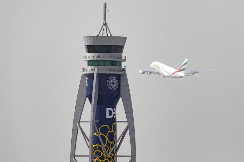 An Airbus SE A380-800 aircraft, operated by Emirates, takes off past the control tower.