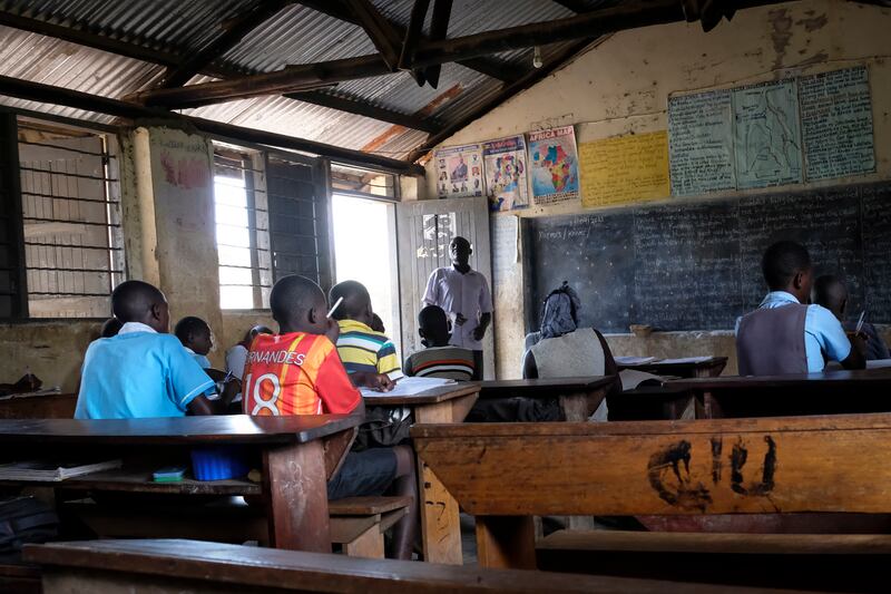 A teacher takes a primary school class at Madudu Catholic Church school, where many pupils stayed away owing to the risk of Ebola. AP