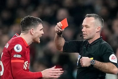 Referee Paul Tierney, right, shows a red card to Liverpool's Andrew Robertson during the English Premier League soccer match between Tottenham Hotspur and Liverpool at the Tottenham Hotspur Stadium in London, Sunday, Dec.  19, 2021.  (AP Photo / Frank Augstein)