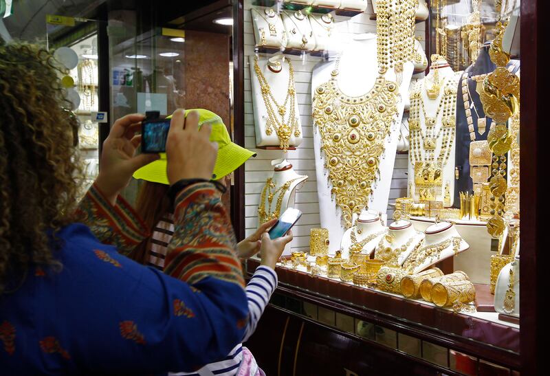 Dubai, United Arab Emirates - March 2, 2014.  Tourists view and buy jewels at the famous gold shops in the Gold Souk.  ( Jeffrey E Biteng / The National )  Editor's Note;  Andy S reports.  Shops don't allow photography inside.