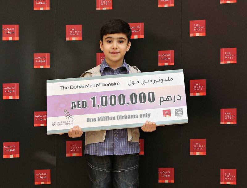 Saif A H, 7, from RAK, with his cheque from The Dubai Mall Millionaire draw, of which he is the youngest winner this year. Courtesy The Dubai Mall