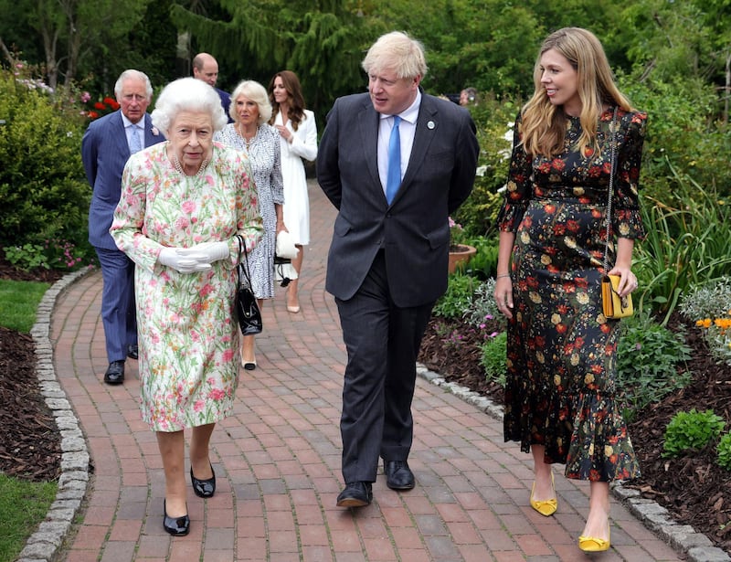 epa09263429 A handout photo made available by 10 Donwing Street shows Britain's Queen Elizabeth II (L) with Britain's Prime Minister Boris Johnson (C) and his wife Carrie (R) walking at a reception during the G7 summit in St Austell, Cornwall, Britain 11 June 2021. Britain is hosting the Group of Seven (G7) summit in Cornwall in from 11 to 13 June 2021.  EPA/ANDREW PARSONS/DOWNING STREET / This image is for Editorial use purposes only. The Image can not be used for advertising or commercial use. The Image can not be altered in any form. Downing street handout. HANDOUT EDITORIAL USE ONLY/NO SALES
