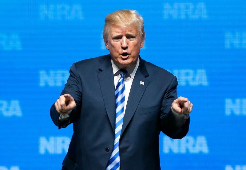 President Donald Trump gestures to the audience after speaking at the National Rifle Association annual convention in Dallas, Friday, May 4, 2018. (AP Photo/Sue Ogrocki)