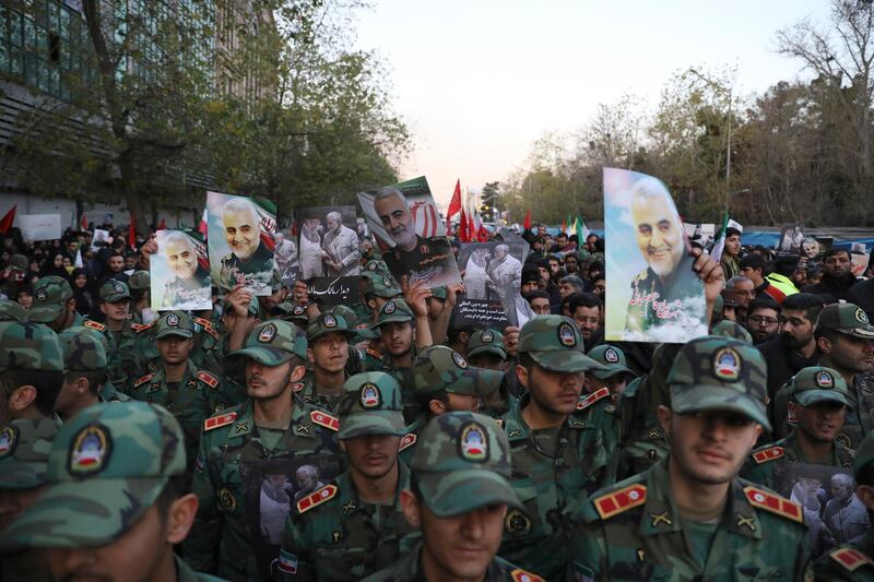 Army cadets attend a funeral ceremony for Qassem Suleimani, shown in posters, and his comrades at the Enqelab-e-Eslami (Islamic Revolution) square in Tehran. AP