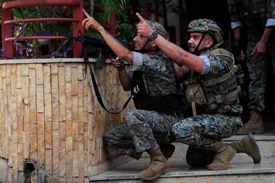 Lebanese security forces react to gunfire during a protest in Beirut in 2021. AP