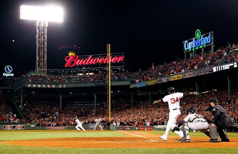 David Ortiz hit his first post-season grand slam Sunday night to tie it 5-5 in the eighth inning. Jared Wickerham / Getty Images / AFP