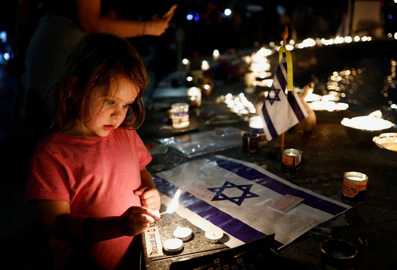 People gather in Tel Aviv for a candlelit vigil to mark the one-month anniversary of the October 7 deadly attack by Hamas militants on Israel. Reuters