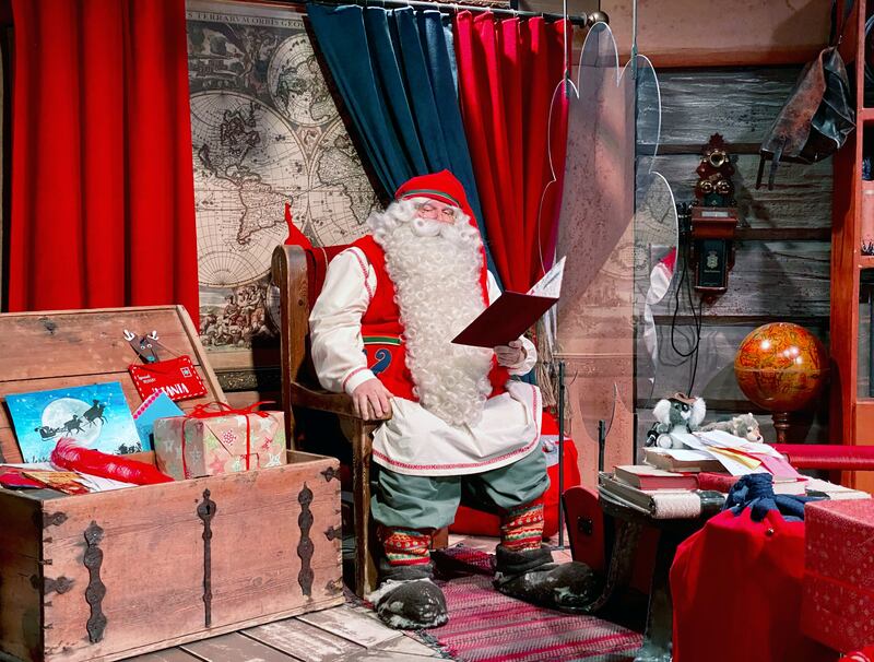Santa Claus is pictured in his chamber behind a plexiglas screen at Santa Claus Village in the Arctic Circle near Rovaniemi, Finland October 13, 2020. Normally Santa's village in northern Finland is bustling with visitors in the months before Christmas but this year the pandemic has made them stay away, plunging the tourist attraction into crisis. Picture taken October 13, 2020.  REUTERS/Attila Cser