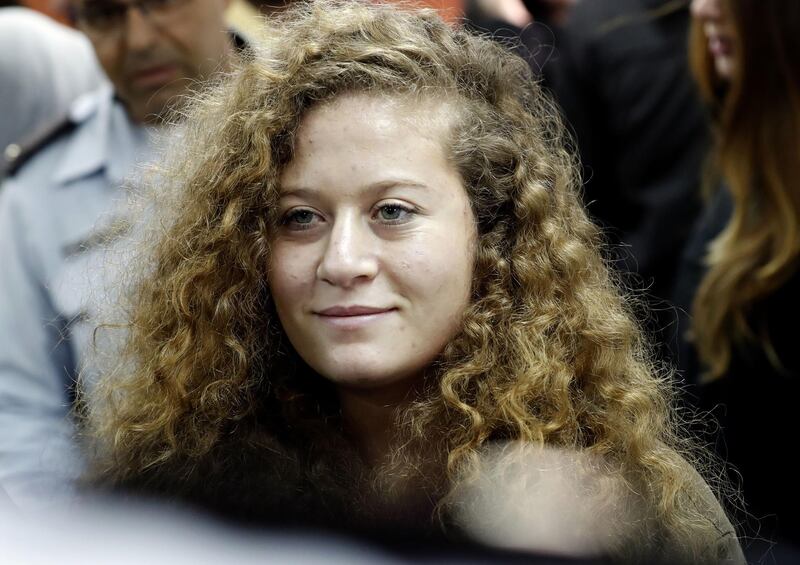 Seventeen-year-old Palestinian Ahed Tamimi (R), a well-known campaigner against Israel's occupation, arrives for the beginning of her trial in the Israeli military court at Ofer military prison in the West Bank village of Betunia on February 13, 2018. 
The Israeli military trial of a Palestinian teenager charged after a viral video showed her hitting two soldiers in the occupied West Bank began behind closed doors. The judge in the trial ordered journalists removed from the courtroom, ruling that open proceedings would not be in the interest of 17-year-old Ahed Tamimi, who is being tried as a minor.
 / AFP PHOTO / THOMAS COEX