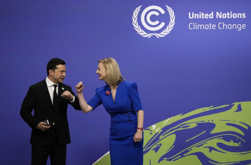 Ms Truss greeting Ukraine's President Volodymyr Zelenskyy at the Cop26 summit in Glasgow, in November 2021.  PA