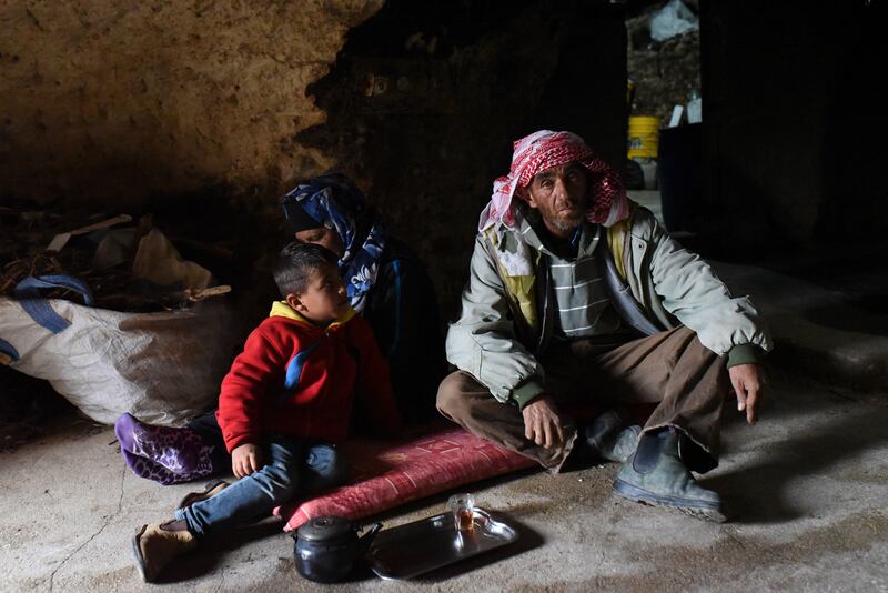 Palestinian shepherd Fadel Hassan Hamamdi sits with his family in a cave in the village of Mufaqarah. All photos: Rosie Scammell / The National