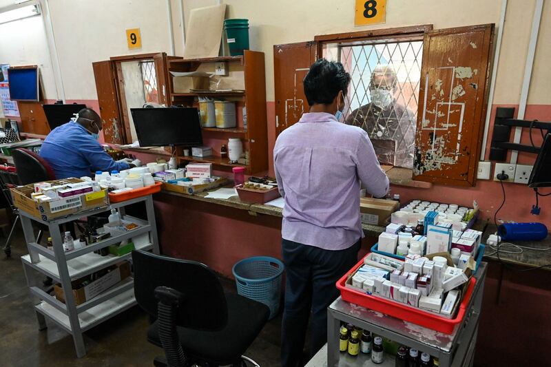 A pharmacist attends to a man in Lady Ridgeway Hospital for Children. AFP