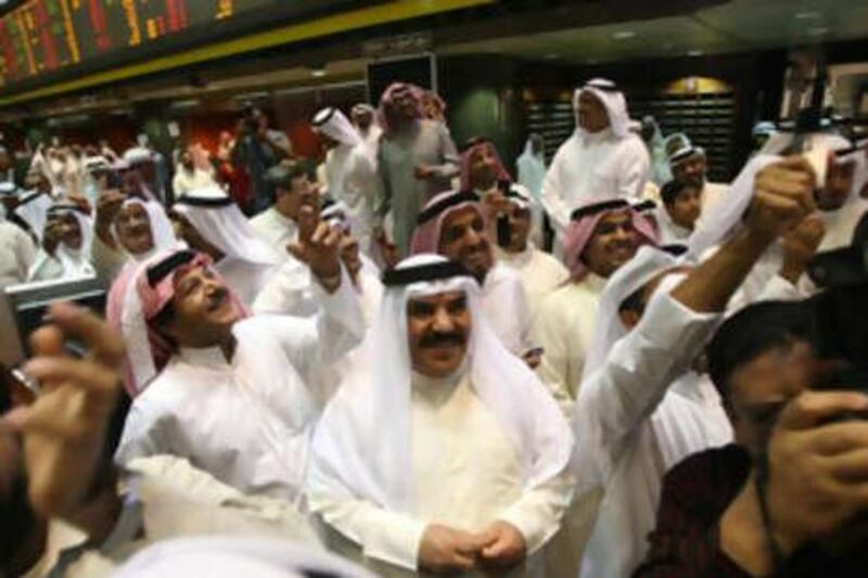 Kuwaiti traders celebrate after trading was halted at the Stock Exchange in Kuwait City on November 13, 2008. Trading at the Kuwait Stock Exchange, the second largest Arab bourse, was halted today following an unprecedented court order aimed at curbing the market's slide and preventing massive losses among small investors. Trading will be suspended until November 17 when the court will sit again to look into the issue. AFP PHOTO/YASSER AL-ZAYYAT *** Local Caption ***  695812-01-08.jpg