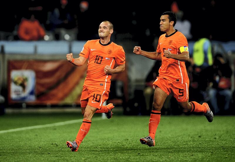 CAPE TOWN, SOUTH AFRICA - JULY 06:  Wesley Sneijder of the Netherlands celebrates scoring his side's second goal with team mate Giovanni Van Bronckhorst (R) during the 2010 FIFA World Cup South Africa Semi Final match between Uruguay and the Netherlands at Green Point Stadium on July 6, 2010 in Cape Town, South Africa.  (Photo by Laurence Griffiths/Getty Images)